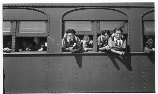 A group of Hawaiian evacuees waiting for the segregation train to start. -- Photographer: Lynn, Charles R. -- Dermott, Arkansas. 9/19/43. Source.