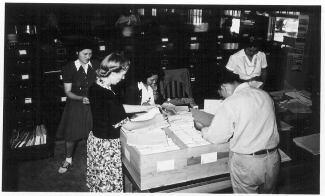 Left to right are Masako Mikami, Miss Gladys Townsend, Chiyoka Kawanami, George Nakaji, Aiko Nishikata of the Jerome Office Services Section assembling the files for persons being transferred to Tule Lake. -- Photographer: Lynn, Charles R. -- Dermott, Arkansas. 9/19/43. Source.