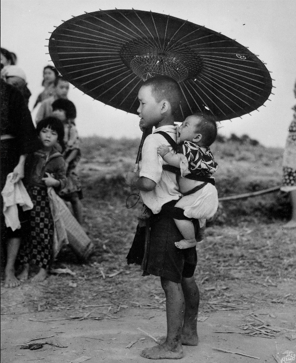 Children stand on the road during the Battle of Okinawa. Wikimedia Commons/National Archives and Record.
