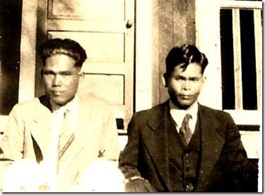 photograph of Hoichi wearing a dark suit with his younger brother Raymond Hotoku Inafuku.  In 1917 when uncle Raymond was 13 years old, he came to Hawaii from Okinawa to live with his Inafuku family in Kauai.  This photograph was probably taken when uncle Raymond went to visit Hoichi in Kauai.