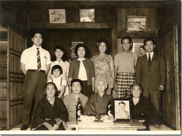 photograph of the Inafuku family in Okinawa below was taken in the Inafuku Taira house’s middle room.  Standing from left to right, Yasuo’s younger brother Yasumune, Yasuo’s sister Toyoko, my Dad’s wife Ruth, my Dad with the checkered shorts, and cousin Yasuo wearing the dark business suit.  Yasuo’s youngest sister Mitsuko is the little girl standing. Sitting from left to right is Yasuo’s mother-in-law Sho Tokuda, Hoichi’s widow Kame Inafuku, Hoichi and my Dad’s aunty Toku Shinjo, and Kamado Taira Inafuku who is uncle Hoso Inafuku’s wife who my Dad lived with when he was in Okinawa as a little boy.