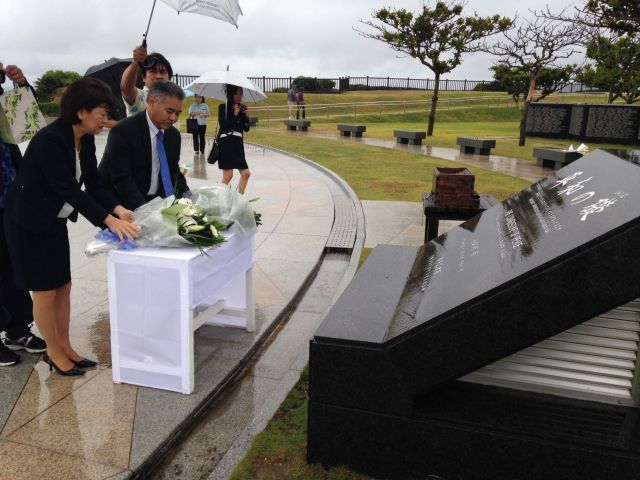 Laying fresh flowers at the Cornerstone of Peace, a monument which commemorates the Battle of Okinawa and the end of World War II. — in Itoman, Okinawa.