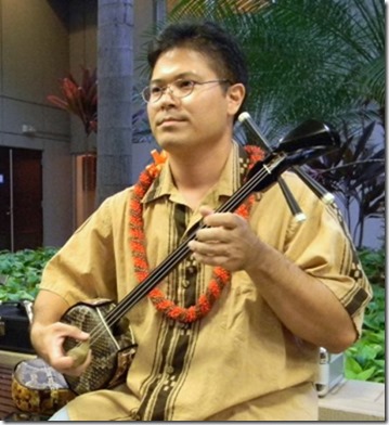 Norman Kaneshiro, singing and playing the sanshin.
